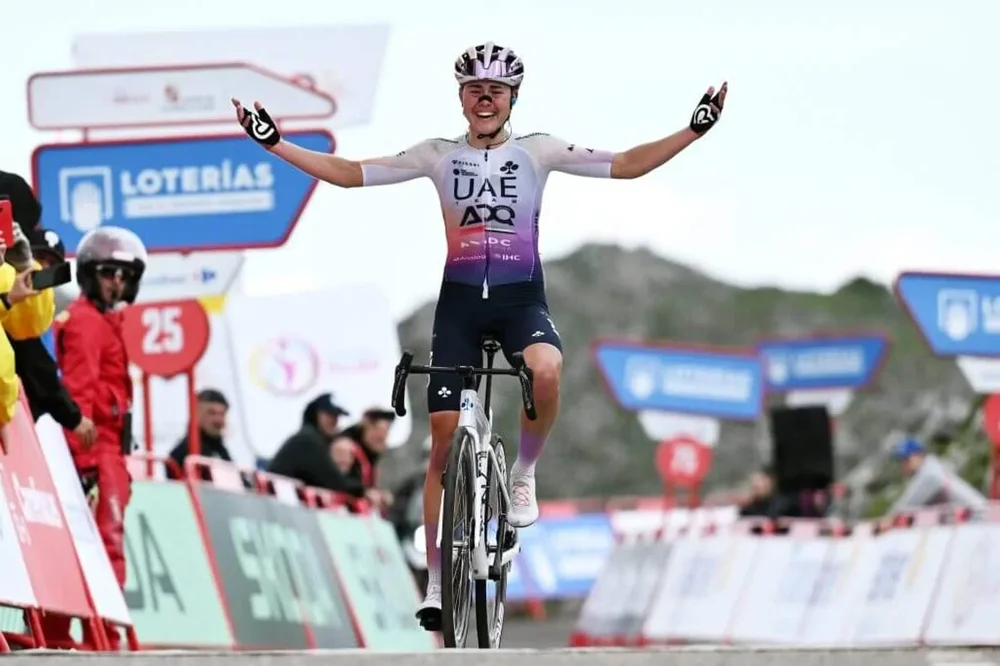 Blasi with her arms outstretched on her bike